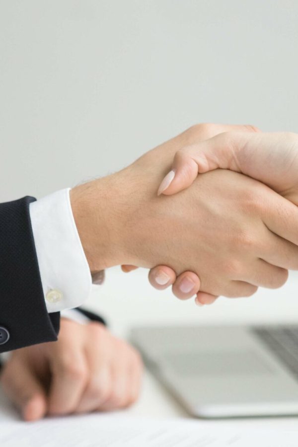 Employment handshake concept, female hr and successful woman candidate shaking hands getting hired ready to sign job contract concept, employer congratulating welcoming new worker, close up view